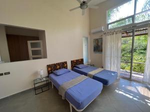a bedroom with two beds and a window at Villas Isla Escondida in Boca Chica +127 photos