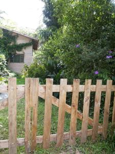 a wooden fence in front of a house at Condominio Costa do Sol Praia - 600mt da praia in Bertioga