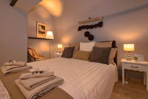 a bedroom with a large bed with towels on it at Heraclea Residential Apartments in Hvar