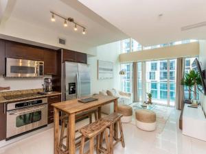 a kitchen with a table and a counter top at Beautiful Brickell Loft with Free Parking in Miami