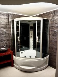 a bath tub in a room with a wall at Korfe Estate in Fodele