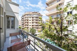 a balcony with two benches and buildings at #White Lotus by halu! Apartments in Thessaloniki