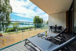 a patio with a table and chairs on a balcony at Olimpijska Premium by RENT4YOU in Olsztyn