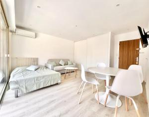 a bedroom with a bed and a table and chairs at Residence Eden Juan les Pins Plages Juanita by Weekome in Juan-les-Pins