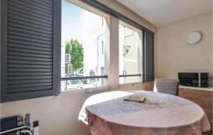 a room with a table and a large window at Awesome Apartment In Vallauris With Kitchenette in Vallauris
