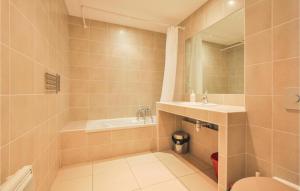 a bathroom with a sink and a toilet and a mirror at Awesome Apartment In Vallauris With Kitchenette in Vallauris