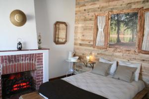 a bedroom with a bed and a fireplace at Santa Maria do Mar Guest House in Peniche