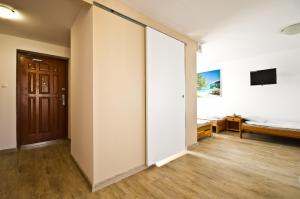 a room with a bed and a sliding door at Wind4You in Dąbki