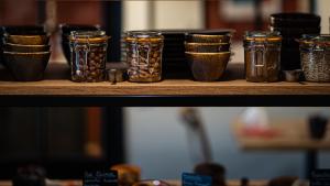 a shelf with jars filled with nuts and seeds at Hôtel Vauban in Le Palais