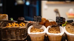 a display of breads in baskets on a table at Hôtel Vauban in Le Palais