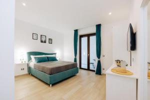 a bedroom with a bed and a television in it at Maison Lorelle Sorrento in Sorrento