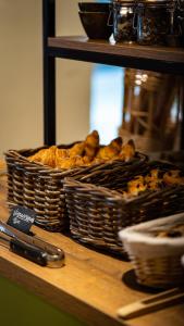dos cestas de pan sentadas en una mesa en Hôtel Vauban, en Le Palais