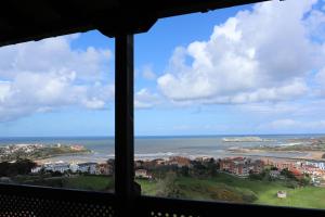 a view of the ocean from a window at Hotel Montañés in Suances
