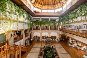an image of the lobby of a building with plants on the ceilings at Princesa Yaiza Suite Hotel Resort in Playa Blanca