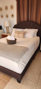 a bed with a wooden headboard and a basket on it at Ocean Village at Combate in Cabo Rojo