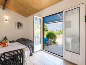 uma sala de jantar com uma mesa e uma porta de vidro deslizante em Holiday Home San Antoine - IRU140 by Interhome em LʼÎle-Rousse