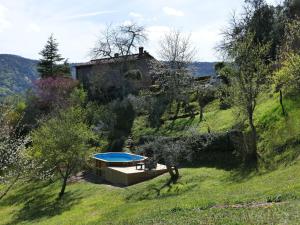 a house on a hill with a swimming pool at Holiday Home Il Casale by Interhome in Lama