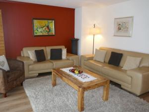 a living room with two couches and a coffee table at Apartment Bodmisunne by Interhome in Grindelwald