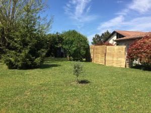a yard with a fence and a house at Holiday Home Orphée - GEM120 by Interhome in Gaillan-en-Médoc