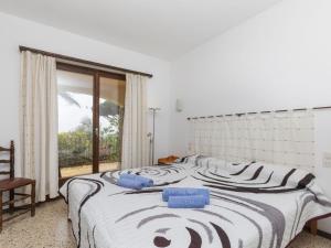 a bedroom with a large bed and a window at Holiday Home Puig Romani-2 by Interhome in Platja  d'Aro