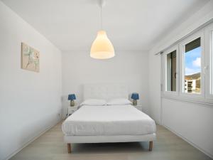 Postel nebo postele na pokoji v ubytování Caslano City Apartments