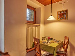 a dining room with a table and chairs and a window at Holiday Home Casa Susanne by Interhome in Spiazzi Di Caprino +15 photos
