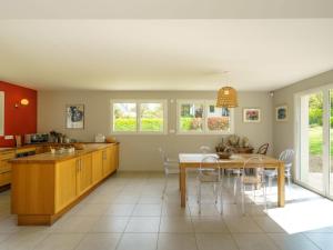 a kitchen and dining room with a table and chairs at Holiday Home du bois du Kador by Interhome in Morgat