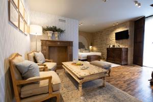 ein Wohnzimmer mit einem Sofa und einem Tisch in der Unterkunft Hotel Cetina Palacio de los Salcedo in Baeza