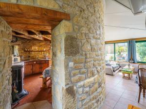 a stone wall in a living room with a fireplace at Holiday Home Le Pigeonnier by Interhome in Roscanvel