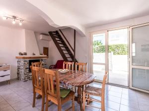 a kitchen and dining room with a table and chairs at Holiday Home Félicité by Interhome in Folelli