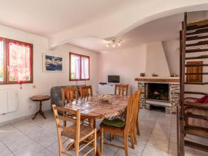 a kitchen and dining room with a table and chairs at Holiday Home Félicité by Interhome in Folelli