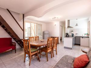 a kitchen and dining room with a table and chairs at Holiday Home Félicité by Interhome in Folelli +12 photos