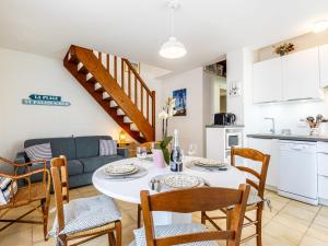 a kitchen and living room with a table and chairs at Holiday Home Les Privileges by Interhome in Saint-Palais-sur-Mer