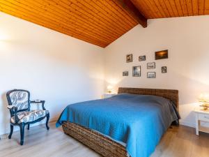 a bedroom with a bed and a chair at Holiday Home Les Privileges by Interhome in Saint-Palais-sur-Mer
