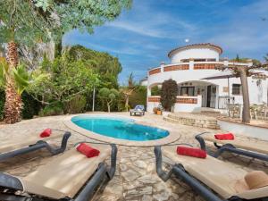 a house with a swimming pool in front of a house at Holiday Home Hamaca by Interhome in Calonge