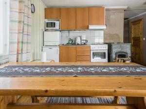 Holiday Home Koivuranta by Interhome في Pohjavaara: مطبخ مع طاولة خشبية في الغرفة