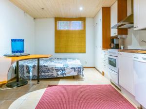 a kitchen with a table and a bed in a room at Holiday Home Pispalan elokuvaranta by Interhome in Tampere