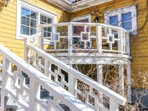 a white balcony on the side of a house at Holiday Home Pispalan elokuvaranta by Interhome in Tampere