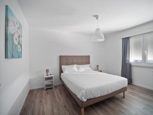 Postel nebo postele na pokoji v ubytování Caslano City Apartments