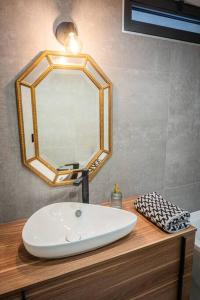 a bathroom with a sink and a mirror on a counter at Villa moderne avec piscine privative in Biguglia +9 photos