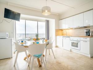 a kitchen and dining room with a table and chairs at Apartment La Balancine by Interhome in Hyères
