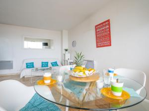 a living room with a glass table with fruit on it at Apartment La Balancine by Interhome in Hyères
