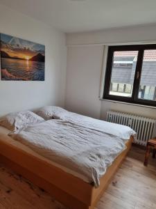 1 dormitorio con 1 cama y 2 ventanas en WohnZeit Stuttgart, en Stuttgart