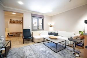 a living room with a white couch and a table at Rafina 1 bedroom 2 persons apartment by MPS in Rafina