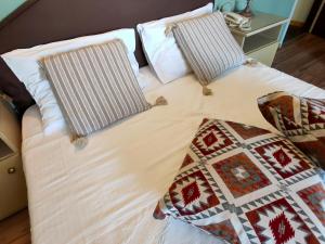 a bed with two pillows on top of it at Galini Hotel Agios Ioannis Pelion in Agios Ioannis Pelio