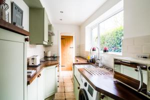 a kitchen with a sink and a window at Laurel Cottage in Lincolnshire