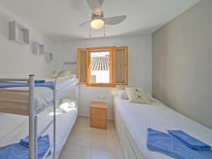 a bedroom with two bunk beds and a window at Apartment Pont del Moncau by Interhome in Altea