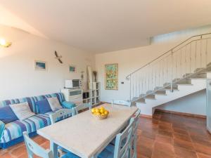 a living room with a couch and a table at Apartment Capo Testa by Interhome in Capo Testa