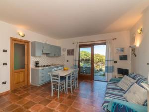 a kitchen and living room with a couch and a table at Apartment Capo Testa by Interhome in Capo Testa