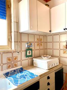 a kitchen with white cabinets and a counter top at LA casa nell'angolo in Marettimo